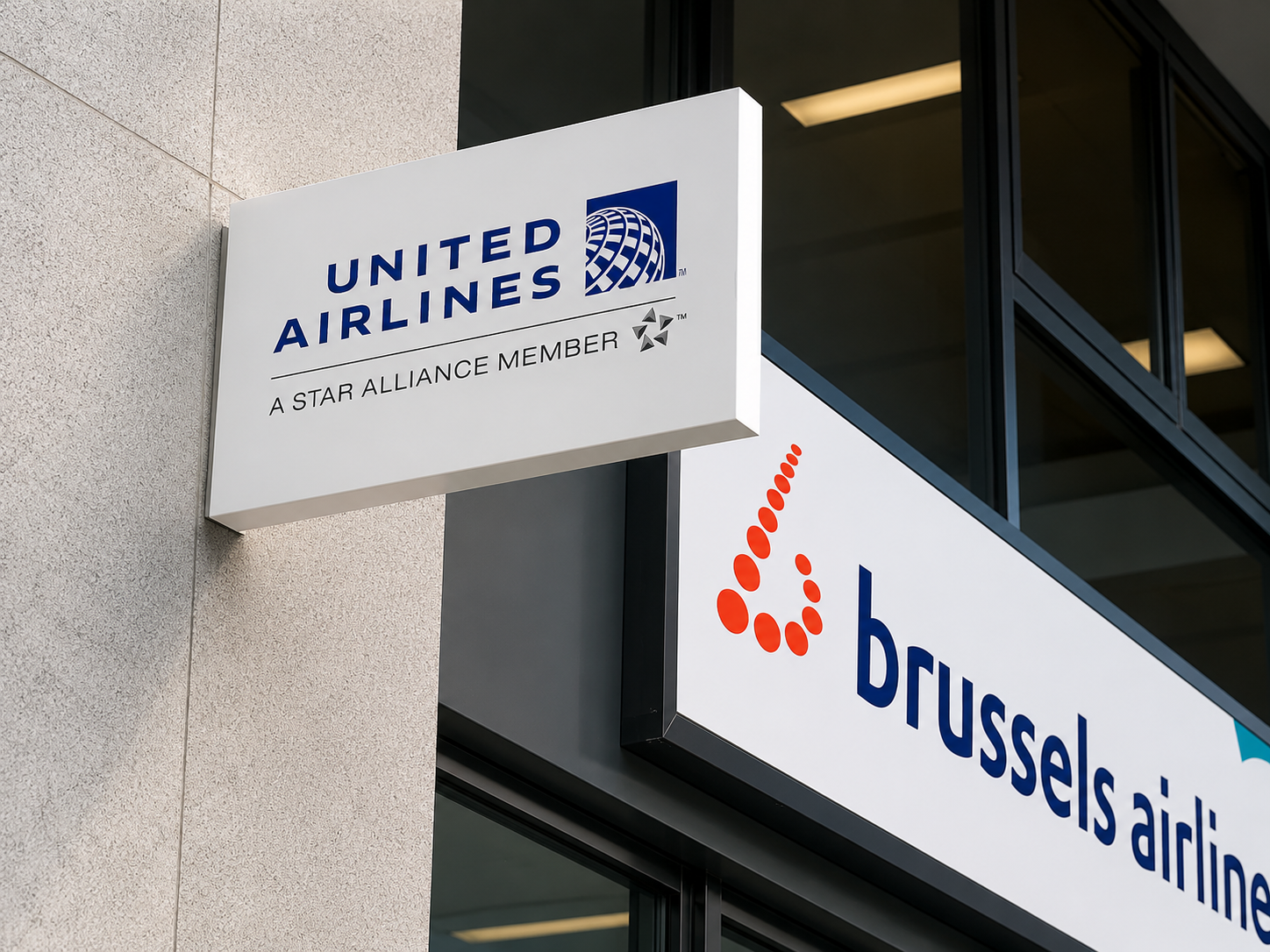 Illuminated United Airlines and Brussels Airlines projecting light box signs