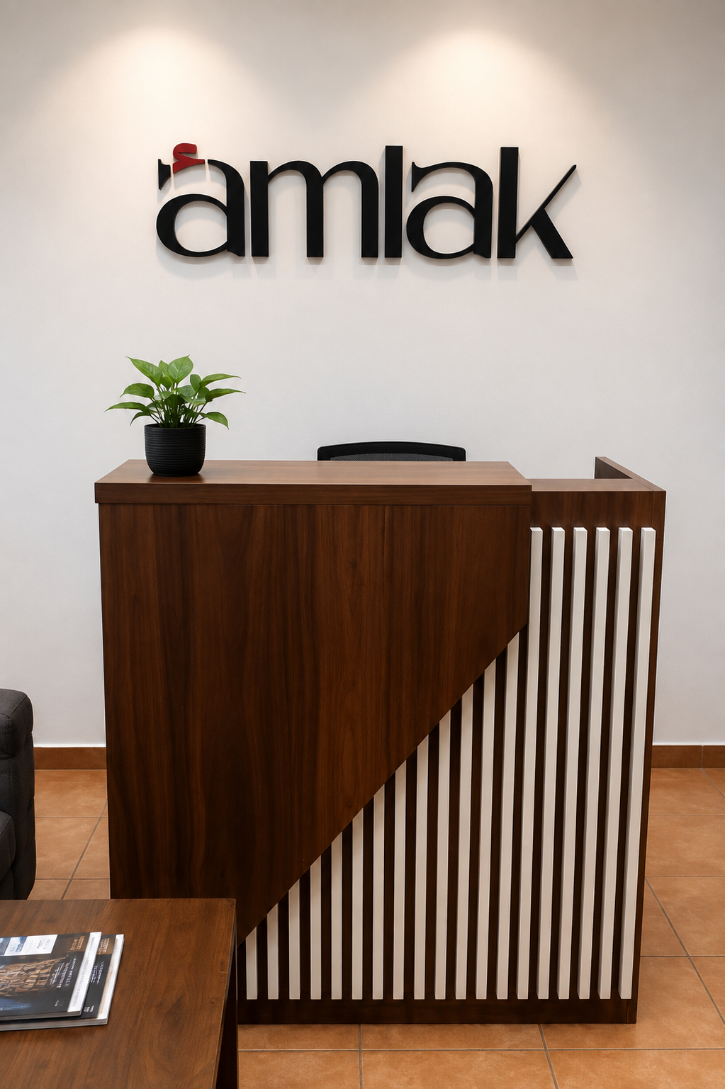 Amlak dimensional logo signage above a reception desk