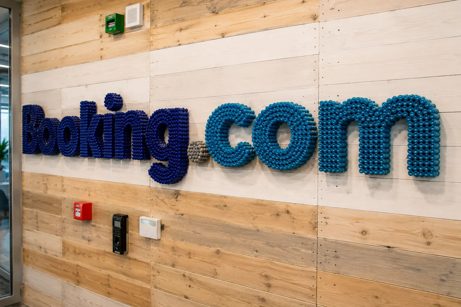 Dimensional Booking.com lettering mounted on an interior wall