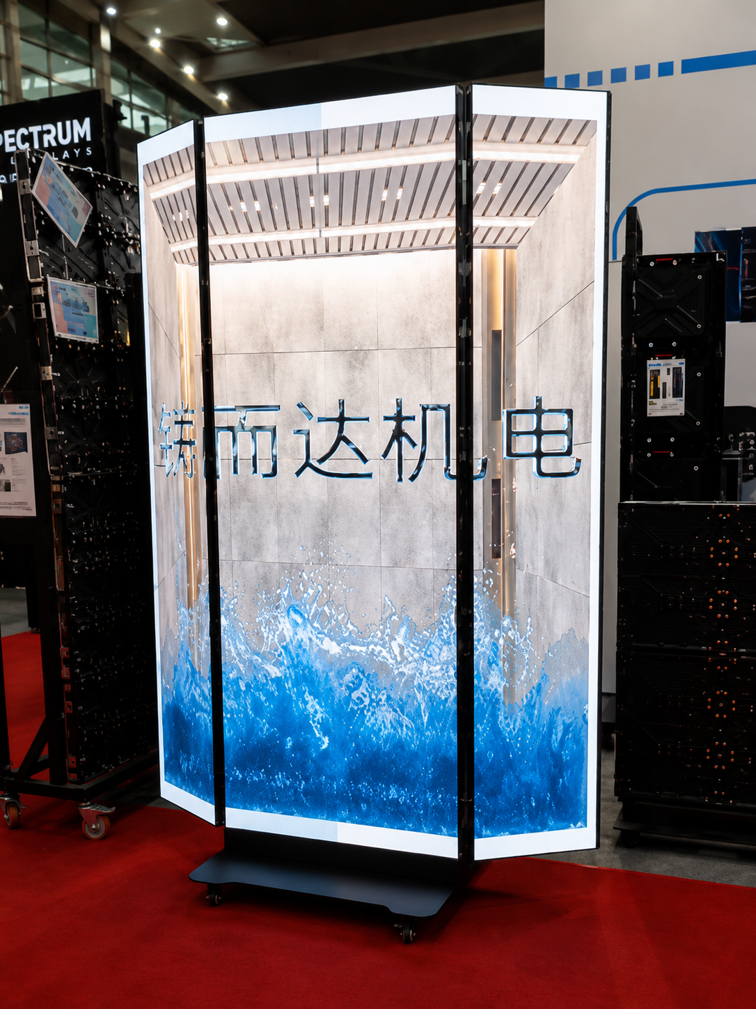 Curved freestanding LED display column showing full-colour content